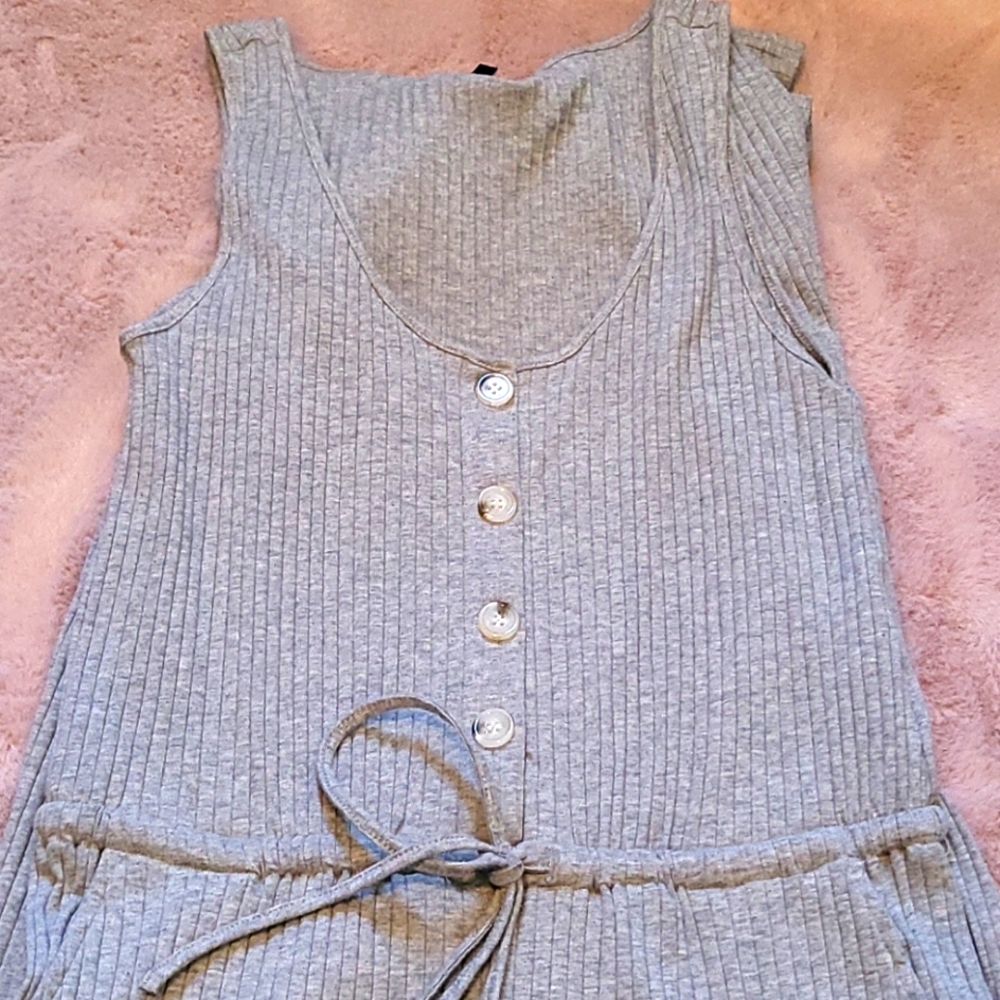 A jumper bodysuit in grey with buttons